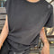 model wearing dark slate relaxed fit cotton tee with muscle type sleeves and side vents