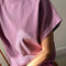 up close of model wearing dusty lilac cotton tee with slight cap sleeves and matching shorts