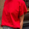 side view of model wearing red relaxed fit tee