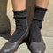 model wearing charcoal grey ribbed scalloped socks with flats