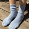 model wearing light blue ribbed scalloped socks