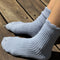 side view of model wearing light blue ribbed scalloped socks