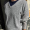 model wearing light grey v-neck sweater