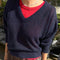 model wearing navy v-neck sweater