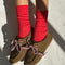 model wearing poppy red pointelle socks