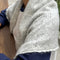 model wearing heather grey pointelle square shawl with scalloped edges