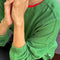 up close of model wearing asparagus long sleeve tee with elastic arm bands and relaxed fit