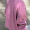 back view of model wearing dusty lilac long sleeve tee with elastic arm bands and relaxed fit