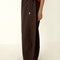 side view of model wearing dark brown oversized parachute pants