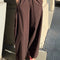 model wearing dark brown oversized parachute pants