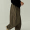 side view of model wearing olive green parachute cotton pants