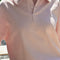 up close of model wearing baby pink relaxed fit polo sweatshirt