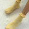 model wearing light yellow ruffle socks