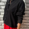 side view of model wearing black snap front cotton cardigan