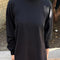 model wearing black cotton long sleeve tunic with mockneck