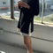 side view of model wearing black long sleeve tee with deep side vents