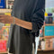 side view of model wearing slate grey long sleeve tee with deep side vents