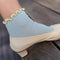 side view of model wearing baby blue socks with butter ruffle trim
