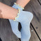 model wearing baby blue socks with butter ruffle trim