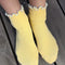 model wearing white socks with baby blue ruffle trim