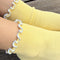 up close of model wearing white socks with baby blue ruffle trim