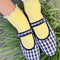 model wearing white socks with baby blue ruffle trim and plaid flats