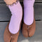 model wearing baby blue socks with butter ruffle trim with brown flats