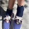 model wearing navy socks with butter ruffle trim and purple sneakers