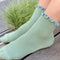 model wearing sea foam socks with baby blue trim