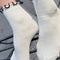 model wearing white socks with navy ruffle trim
