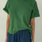 model wearing avocado green relaxed fit tee