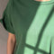 real up close of model wearing avocado green relaxed fit tee