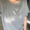 up close of model wearing heather grey relaxed fit tee