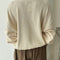 back view of model wearing cream colored waffle sweatshirt with slight balloon sleeves
