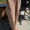 model wearing rust and white gingham relaxed fit pants