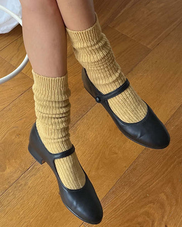 model wearing long mustard socks with black shoes