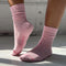 side view of model wearing ballet pink socks with high cuff