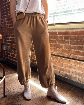 model wearing light brown balloon pants with elastic bottoms