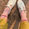 model wearing pink socks with two red stripes and white mary jane shoes
