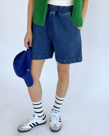model wearing denim shorts with pockets and elastic waist