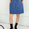 model wearing denim skirt with elastic waist and pockets
