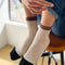 model wearing cream crew socks with brown and black trim
