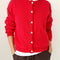 model wearing buttoned chili red cotton cardigan