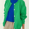 model wearing un-buttoned spring green cotton cardigan