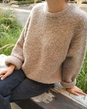 model wearing sand fuzzy relaxed fit sweater