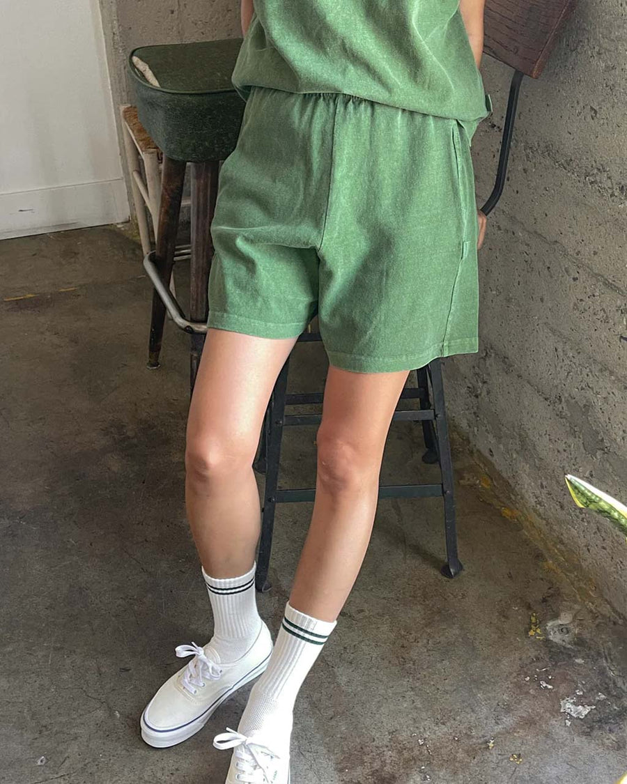 model wearing basil colored cotton shorts
