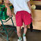 model wearing crayon red colored cotton shorts