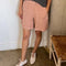 model wearing peach colored cotton shorts