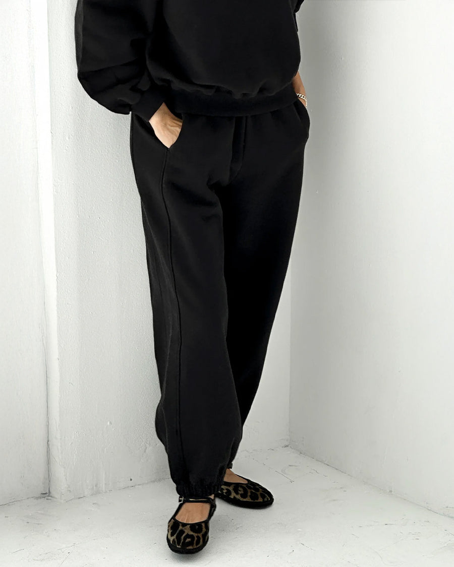 side view of model wearing black french terry balloon cotton pants