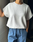 model wearing heather grey french terry short sleeve top